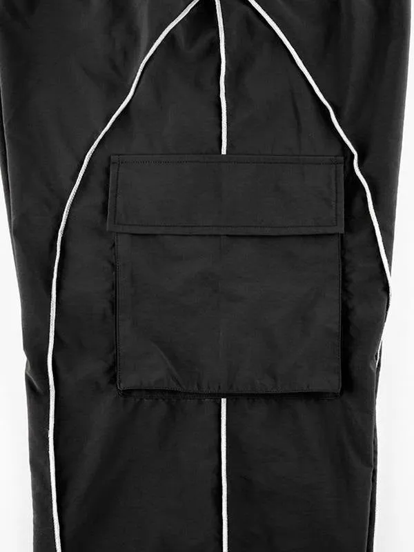Black parachute trousers with cargo pockets and piping details